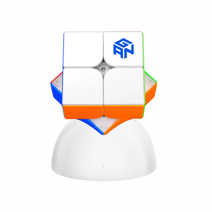 GANCUBE 2x2 magnetic speed cube on a white stand, featuring colored stickers and brand logo.